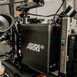 Close-up of a professional ARRI camera rigged for filming in a modern studio.